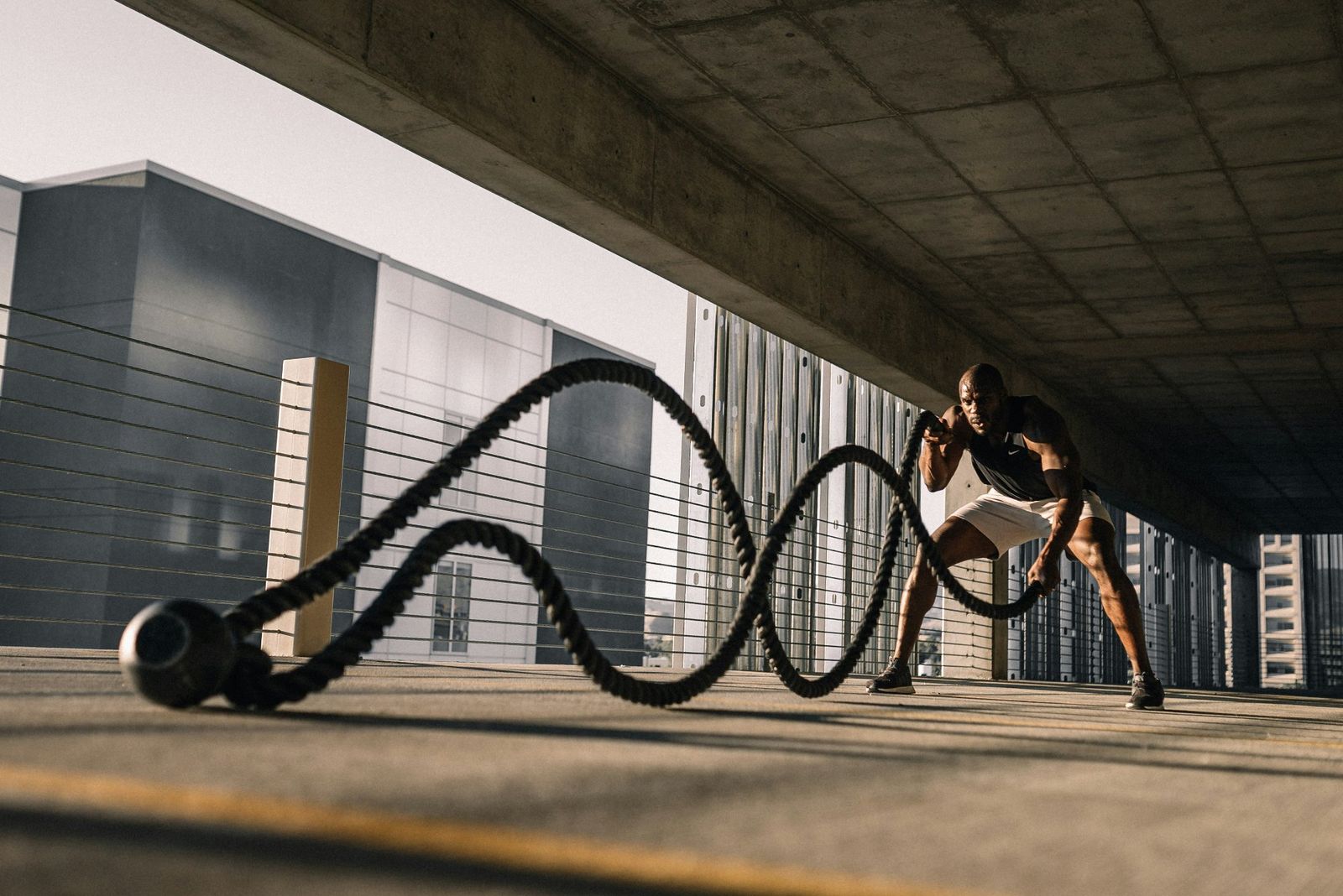 Man doing battle ropes with full intensity and focus