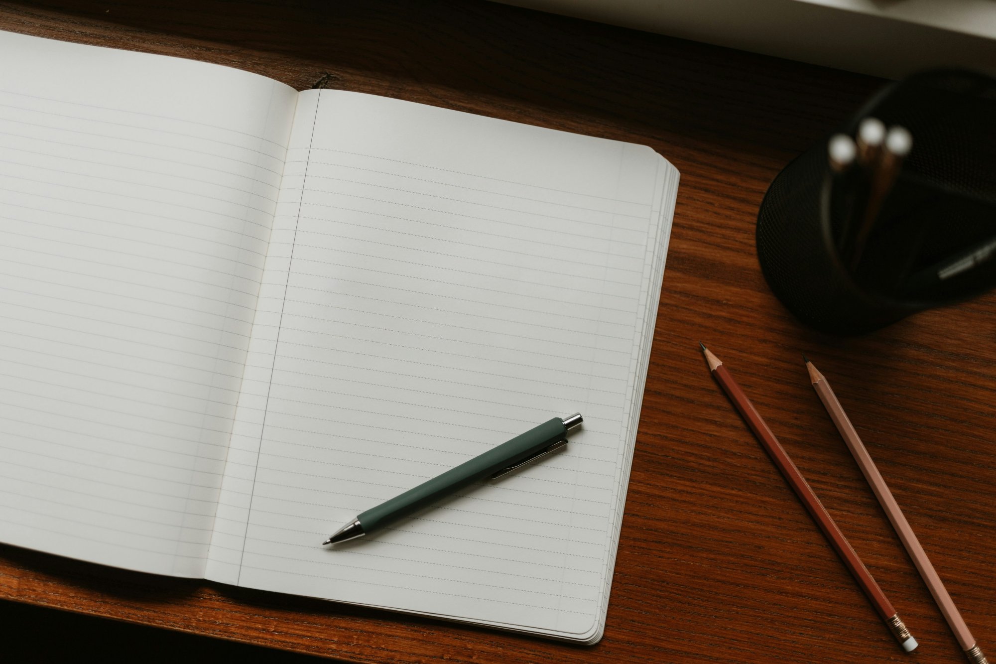 Open lined notebook with a pen on a wooden desk, ready for journaling for anxiety